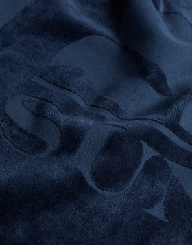 TOALLA DE ESPUMA JACQUARD CON LOGOTIPO Y BORDE